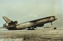 An abandoned World Airways DC- airplane sitting on its tail because of the weight of wet volcanic ash from the  Mount Pinatubo eruption 