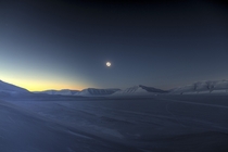 An eclipse looms over the icy peaks of Svalbard Norway in March  By Luc Jamet w links in comments 