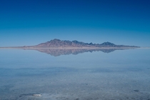 An island reflecting in the great Salt Lake in Utah The water and sky meeting at the horizon 