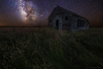 An old decaying schoolhouse under the Milky Way in South Dakota  by Aaron J Groen