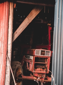 An old international peeking out from the barn