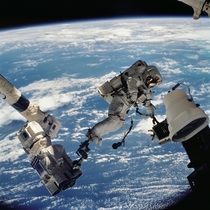 Anchored to a foot restraint on the Space Station Remote Manipulator System or Canadarm astronaut David A Wolf STS- mission specialist participates in the missions first session of EVA -- Oct   