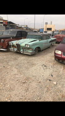 And abandoned ford edsel next to an austin a