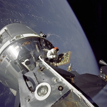 Apollo  CommandService Modules nicknamed Gumdrop and Lunar Module nicknamed Spider are shown docked together as Command Module pilot David R Scott stands in the open hatch on March   