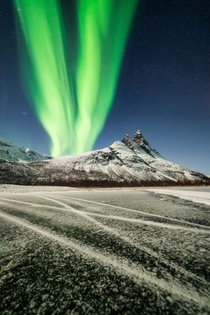 Aurora columns rising next to the picturesque m-high Otertinden-mountain located in the beautiful Signaldalen-valley in N-Norway on a moonlit night   mpxmark