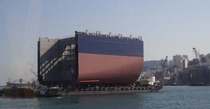 Barge transports Superblock section of a cargo ship under construction Busan Korea 