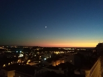 Beautiful sunset with the moon and the stars appearing in the sky