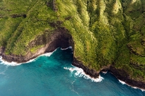 Below a rumpled blanket of green a dramatic Kauai coastline 
