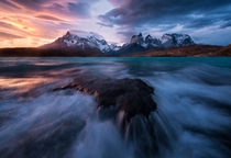 Blazing lenticularis clouds during a stormy sunset at Torres del Paine Chile 
