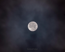 Blue Moon through a layer of clouds