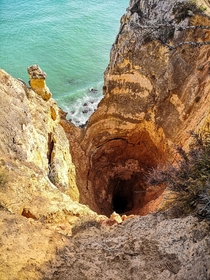 Breathtaking hole near Lagos Portugal Its at least  meters  feet deep and completely unprotected My wife was terrified simply watching me taking this picture 