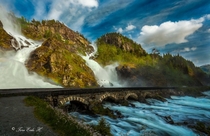 Bridge over waterfall in Ltefossen Odda Norway  by Tore H