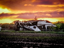 Buckled Abandoned Barn with an Oklahoma Sunset