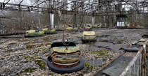 Bumper cars riddled with rust sit in a fairground in Pripyat 