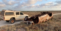 Burnt out old car destroyed in a roll over next to my ute our on a mud flat