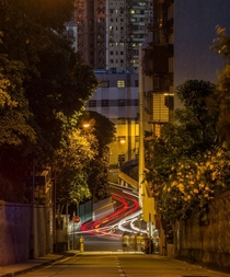 Cars zipping through the hills of Macau  by Tristan OTierney