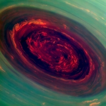 Cassini false color red hues for low clouds and green for high ones near-infrared image of the vortex at Saturns north pole 
