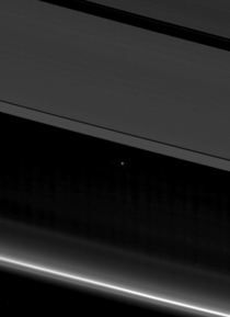 Cassini took a peek inside Saturns rings At the top is the A ring with its broader Encke and narrower Keeler gaps visible At the bottom is F ring The point of light between the rings is Earth amp the pinprick of light to the left is Moon