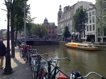 Classic Amsterdam sea of bikes canal DHL delivery boat 