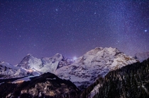 Cloudless winter sky packed with stars over the giant Eiger Mnch and Jungfrau - Lauterbrunnen Switzerland 