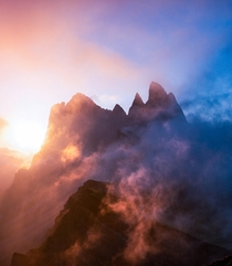 Clouds breaking at sunrise over the peaks of Sass Rigais Italy 