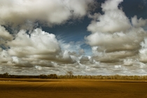 Clouds flying over a freshly plowed field StCloud MN