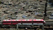 Contrasts Brand new Monorail begins service in Mumbai India passing over a shanty-town 