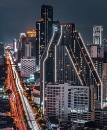 Cyberpunk Bangkok Thailand Thats a condominium in the front named Ideo Q Chula and in the back in all black is the Ashton known for building matte black high rise condos that look epic 
