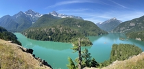Diablo Lake WA - Located in the North Cascades National Park As rock falls down nearby glaciers and into the water it grinds down into a powder-like substance known as glacial flower This flower is what gives the water its turquoise color 