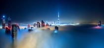 Dubai covered in fog by night 