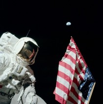 During the first EVA of Apollo  Eugene Cernan photographed Harrison Schmitt with the American flag and the Earth km away in the background Cernan is visible in the reflection in Schmitts helmet visor 