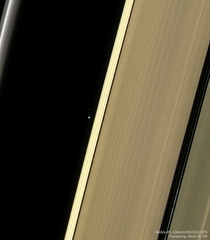 Earth and moon through the rings of Saturn as taken by Cassini probe