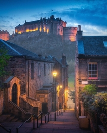 Edinburgh Castle seen from the vennel steps lit with street lamps Edinburgh Scotland