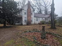 Empty fountain and abandoned colonial house