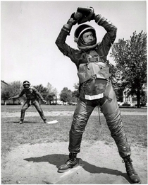 Engineers playing baseball in BF Goodrich Mark IV space suits at US Naval Air Material Center in Philadelphia Pennsylvania ca 