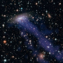 ESO - a spiral galaxy being torn apart to form a jellyfish-like structure as it plows through extremely hot intergalactic gas at a speed of nearly  million miles per hour 
