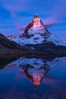 Firat Glow - First glow on an october morning at Riffelsee The Matterhorn in Switzerland by Roland Moser 