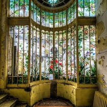 Floral stained glass window at the abandoned Chteau Astremoine in France photo by Urbex