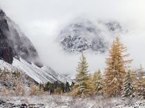 Fog-shrouded mountains in Russias Aktru Valley Photo by   