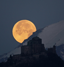 Full moon setting behind Sacra di San Michele 