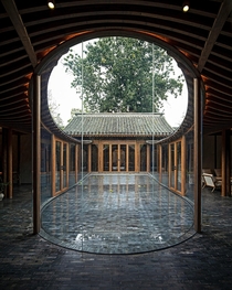 Glass enclosed courtyard in Qishe Courtyard a renovated traditional residence centered around courtyards in the old quarter of Beijing China