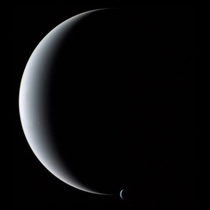Gliding silently through the outer Solar System the Voyager  spacecraft camera captured Neptune and Triton together in crescent phase in  This image of the gas giant planet and its cloudy moon was taken from behind just after closest approach 
