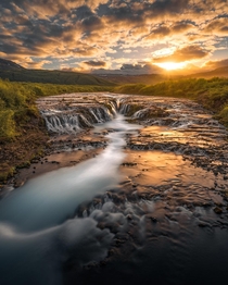 Golden light illuminating a waterfall in Iceland  IG holysht