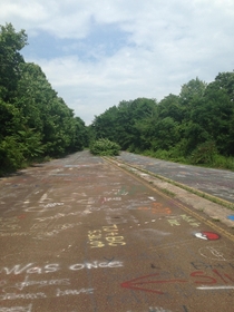 Graffiti highway in the abandoned town on fire Centralia PA Local governments have dumped tons of dirt over the highway to discourage tourists because the ground underneath is still on fire OC 