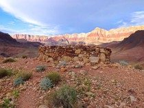 Grand Canyon Arizona Native American watchtower with sun on canyon in the background 