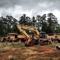 Graveyard of abandoned construction vehicles in Woodstock Georgia 