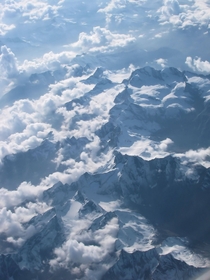 Had a very nice view of the Alps partially covered by clouds in a recent flight 
