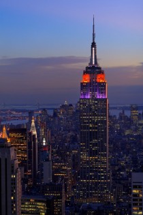 Heres the Empire State Building lit up in purple and orange with lower Manhattan in the background 