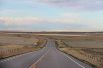Highway  winds through the emptiness of eastern Colorado 