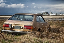 Honda Accord rusting on an abandoned farm near Belle Plaine Saskatchewan